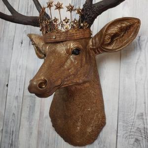 Faux taxidermy deer head that's been painted antique gold with chestnut brown accenting. The antlers are chestnut brown and a vintage inspired Santos star crown/tiara sits arop the deers head.