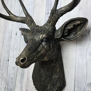 faux taxidermy deer head wall mount, painted black with dark copper accents.