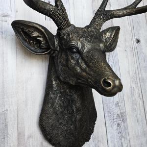 faux taxidermy deer head wall mount, painted black with dark copper accents.