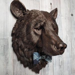 Faux taxidermy bear head painted dark copper with black accenting with mulit dark blue and white fabric bow tie.