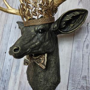 Faux taxidermy deer head with gold metal leaf crown and bow tie.