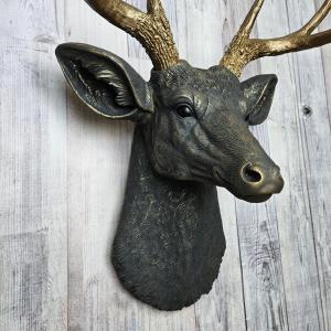Faux taxidermy deer head, painted slate grey with antique gold accents. 