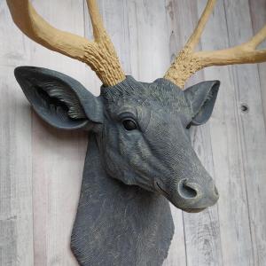 Faux taxidermy deer head that's been painted slate grey with desert sand color accents. The antlers have been painted desert sand.