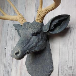 Faux taxidermy deer head that's been painted slate grey with desert sand color accents. The antlers have been painted desert sand.