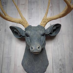 Faux taxidermy deer head that's been painted slate grey with desert sand color accents. The antlers have been painted desert sand.