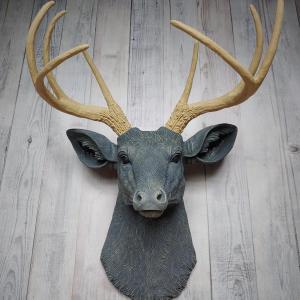 Faux taxidermy deer head that's been painted slate grey with desert sand color accents. The antlers have been painted desert sand.