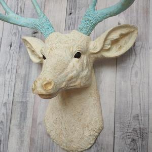 Faux taxidermy deer head, painted antique white with spa blue and gold accents. The antlers are spa blue with gold accents.