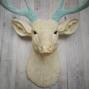Faux taxidermy deer head, painted antique white with spa blue and gold accents. The antlers are spa blue with gold accents.
