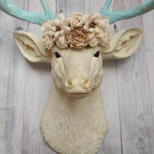 Faux taxidermy deer head, painted antique white with spa blue and gold accents. Antlers are spa blue with gold accents. A removable floral crown made out of cream sola flowers rests atop the deer head