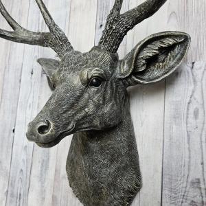 Faux taxidermy deer head, painted chestnut brown with antique white and gold accents. The antlers have been painted the same way.