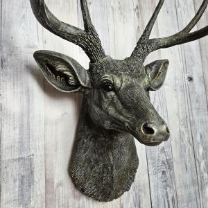 Faux taxidermy deer head, painted chestnut brown with antique white and gold accents. The antlers have been painted the same way.