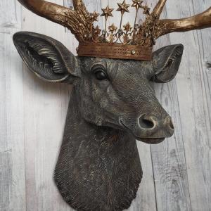 Faux taxidermy deer head, painted chestnut brown with antique white and gold accenting. The antlers are antique gold and a vintage inspired Santos crown sits stop the deers head.