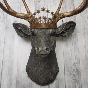 Faux taxidermy deer head, painted chestnut brown with antique white and gold accenting. The antlers are antique gold and a vintage inspired Santos crown sits stop the deers head.
