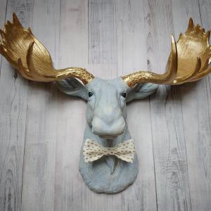 Faux taxidermy moose head painted winter blue with gold antlers with a white and gold polka dot bow tie.