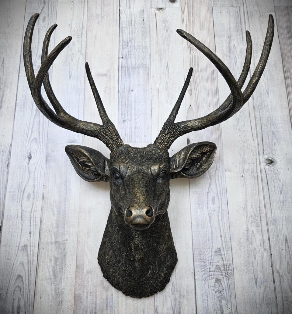faux taxidermy deer head wall mount, painted black with dark copper accents.