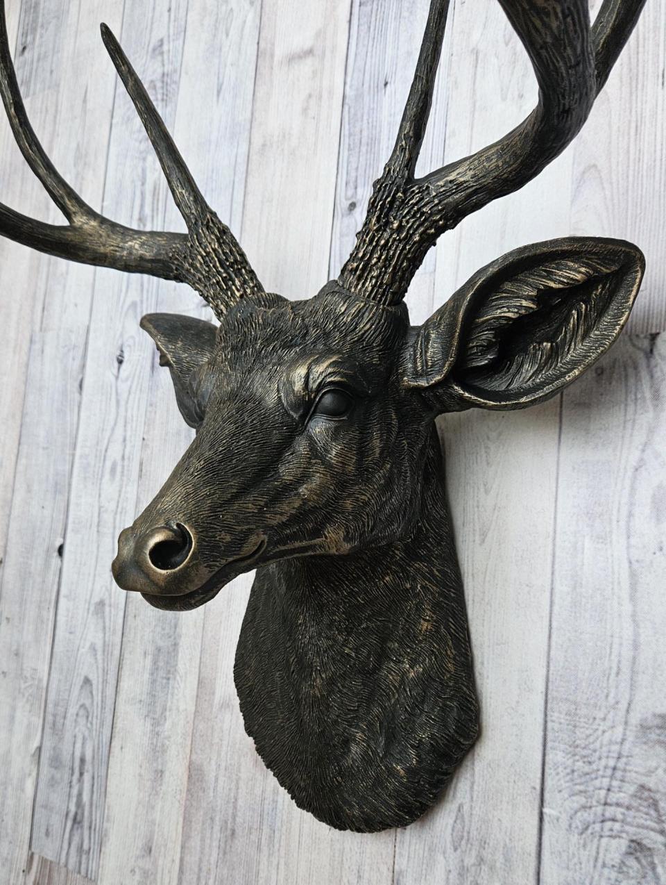 faux taxidermy deer head wall mount, painted black with dark copper accents.