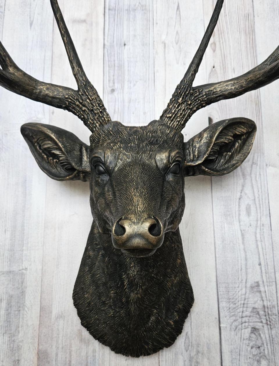 faux taxidermy deer head wall mount, painted black with dark copper accents.