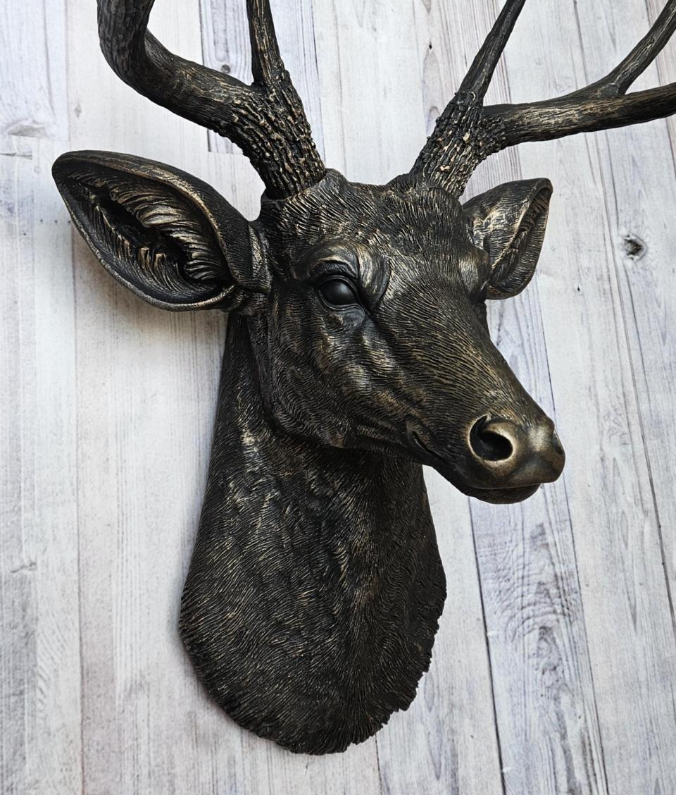 faux taxidermy deer head wall mount, painted black with dark copper accents.