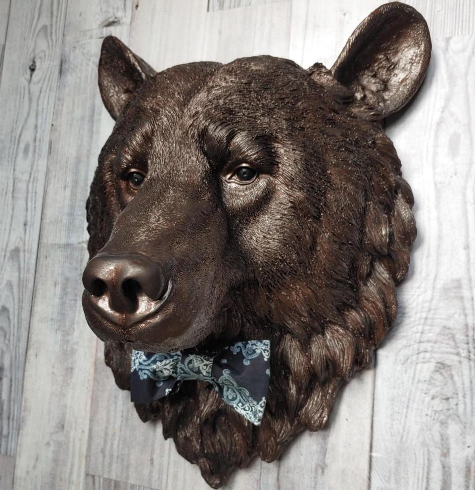 Faux taxidermy bear head painted dark copper with black accenting with mulit dark blue and white fabric bow tie.