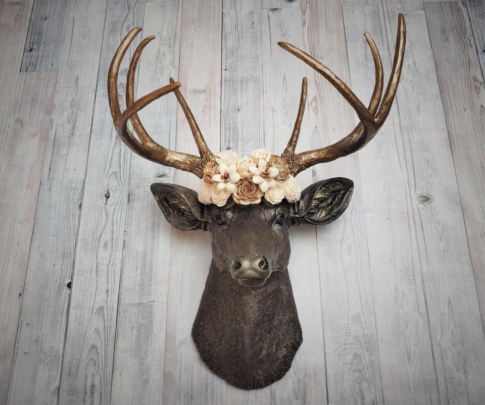 Dark brown and gold faux taxidermy deer head with sola floral crown