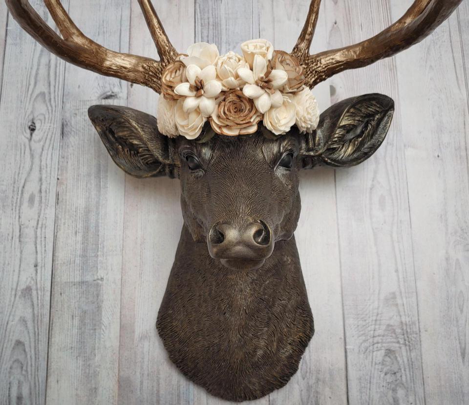 Dark brown and gold faux taxidermy deer head with sola floral crown