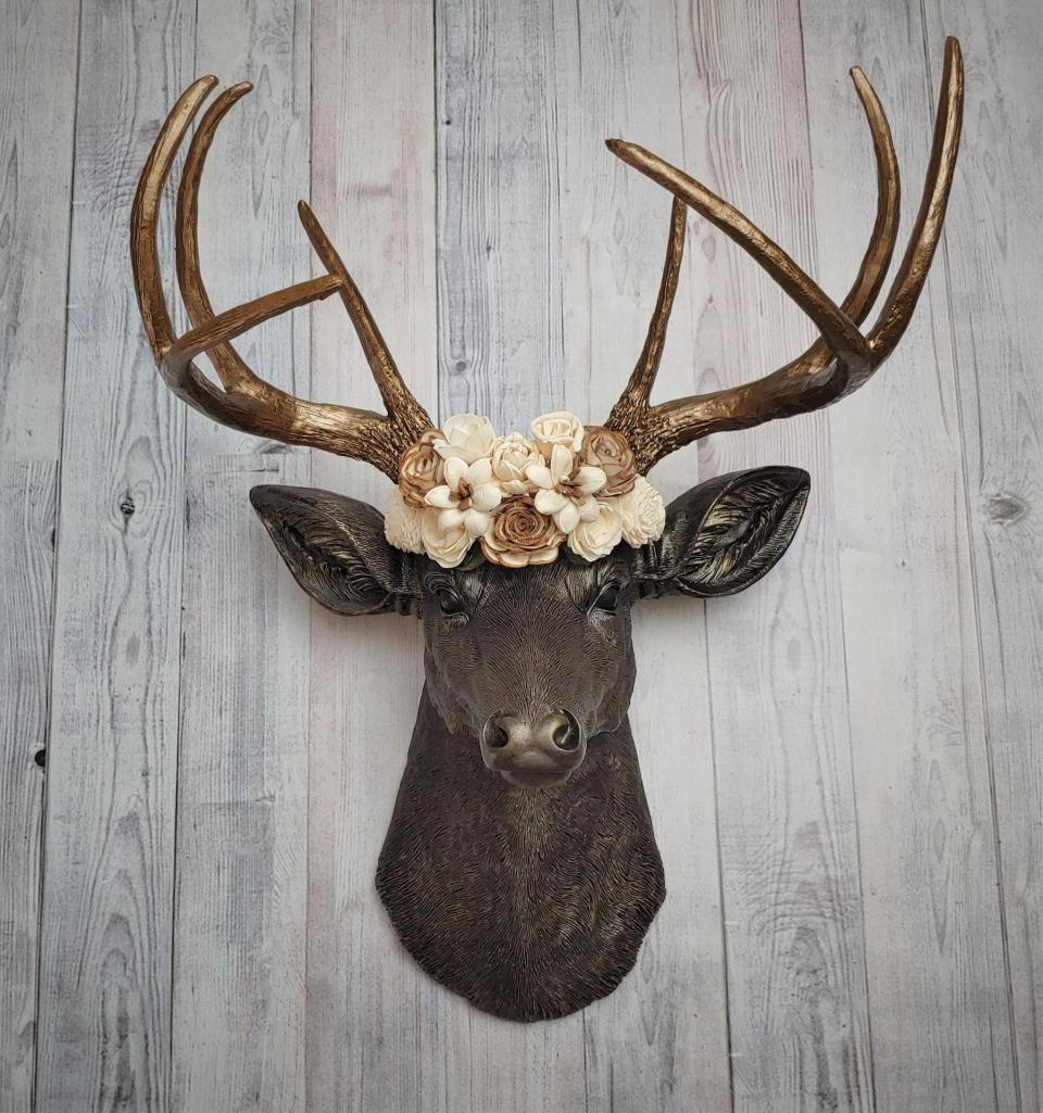 Dark brown and gold faux taxidermy deer head with sola floral crown