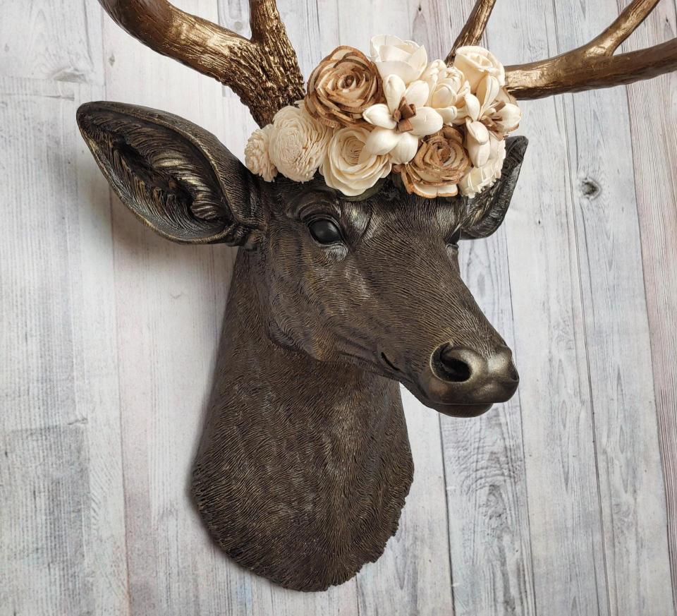 Dark brown and gold faux taxidermy deer head with sola floral crown
