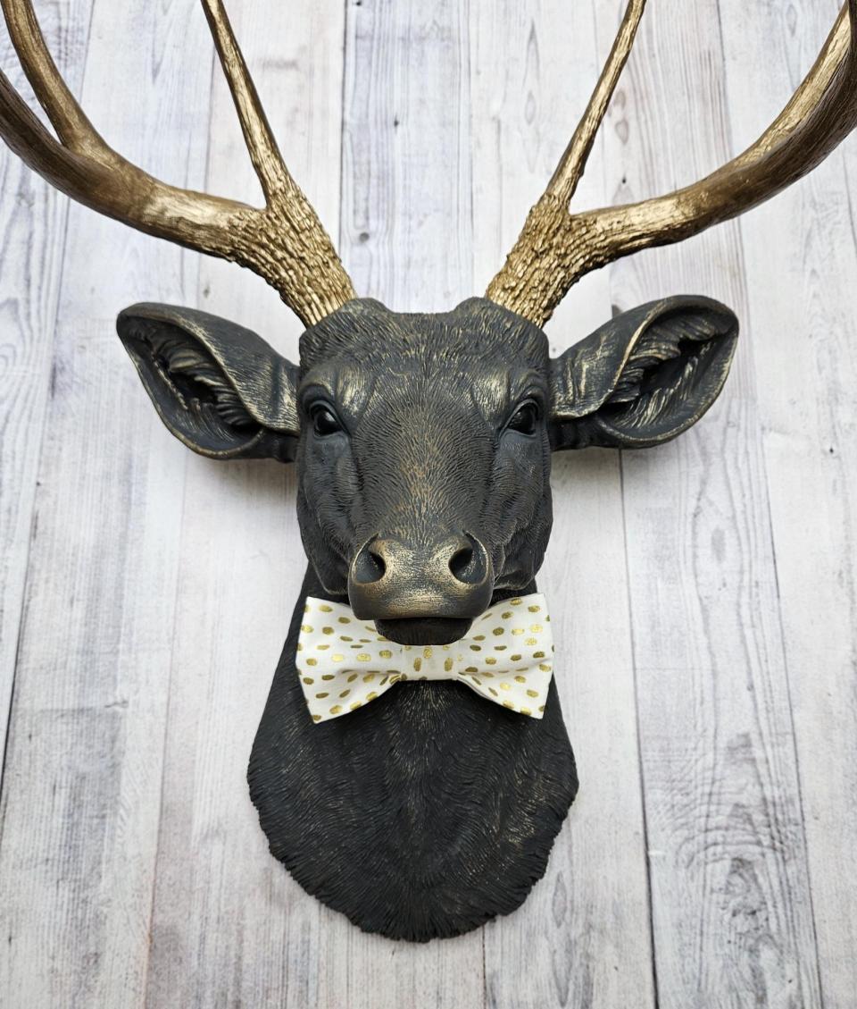 Faux taxidermy deer head, painted slate grey with antique gold accents. 