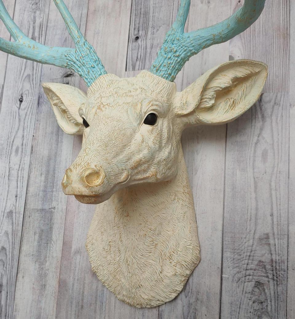 Faux taxidermy deer head, painted antique white with spa blue and gold accents. The antlers are spa blue with gold accents.