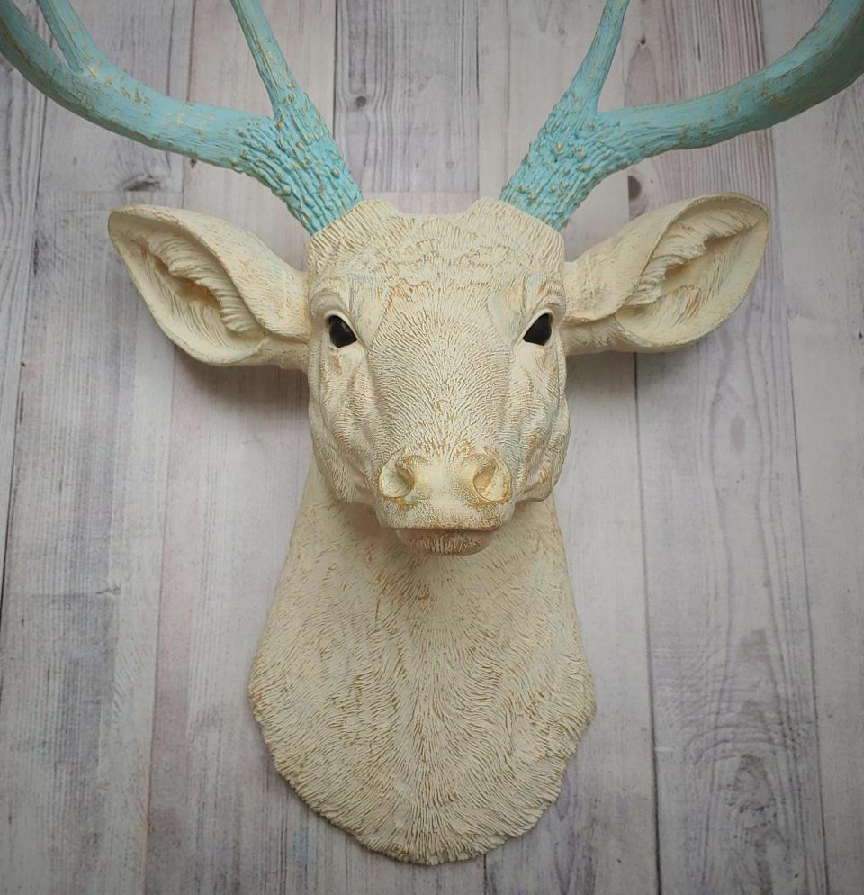 Faux taxidermy deer head, painted antique white with spa blue and gold accents. The antlers are spa blue with gold accents.